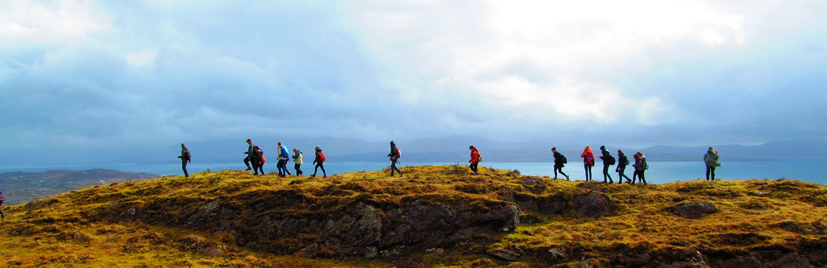Group of people walking along the Irish countryside