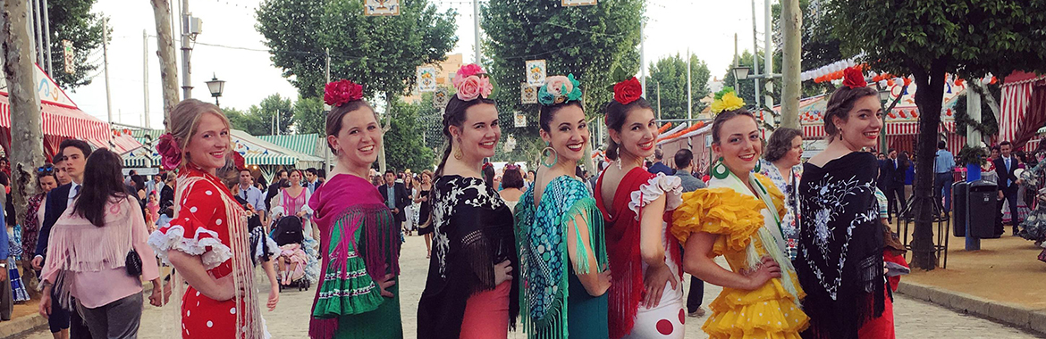 People posing in Spanish dresses