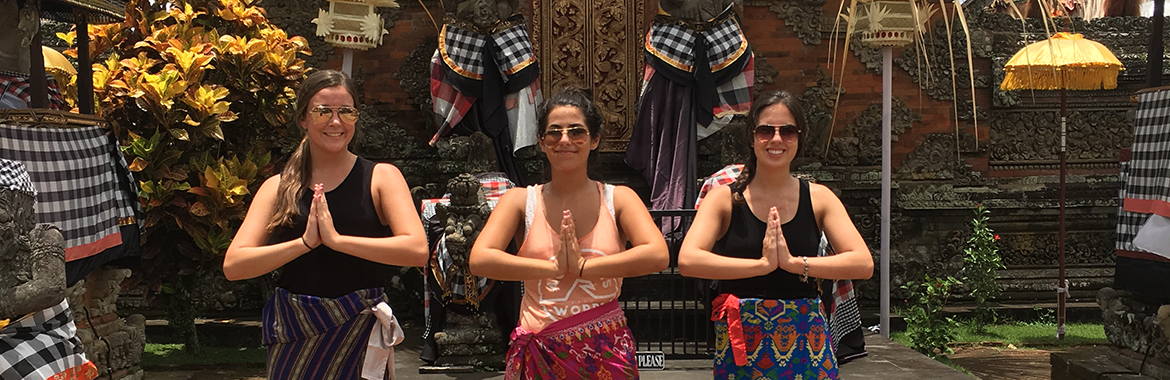 Three people posing with their hands together
