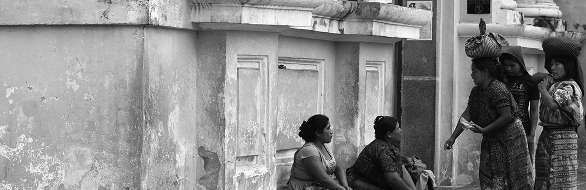 Group of people talking next to a building