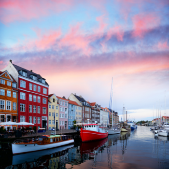 Boats on the water in front of colorful buildings